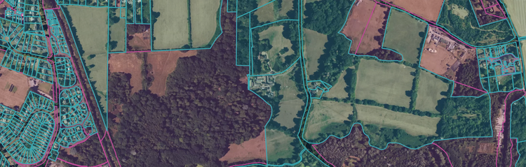 A satelittle view of an area of the midlands, England, overlayed with property boundaries coloured in pink (company owned) and blue (privately owned)